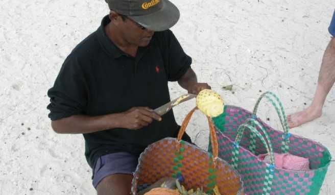 Ananas wird sehr kunstvoll direkt am Strand zubereitet.##Foto: Jörg P. Ananas wird sehr kunstvoll direkt am Strand zubereitet.